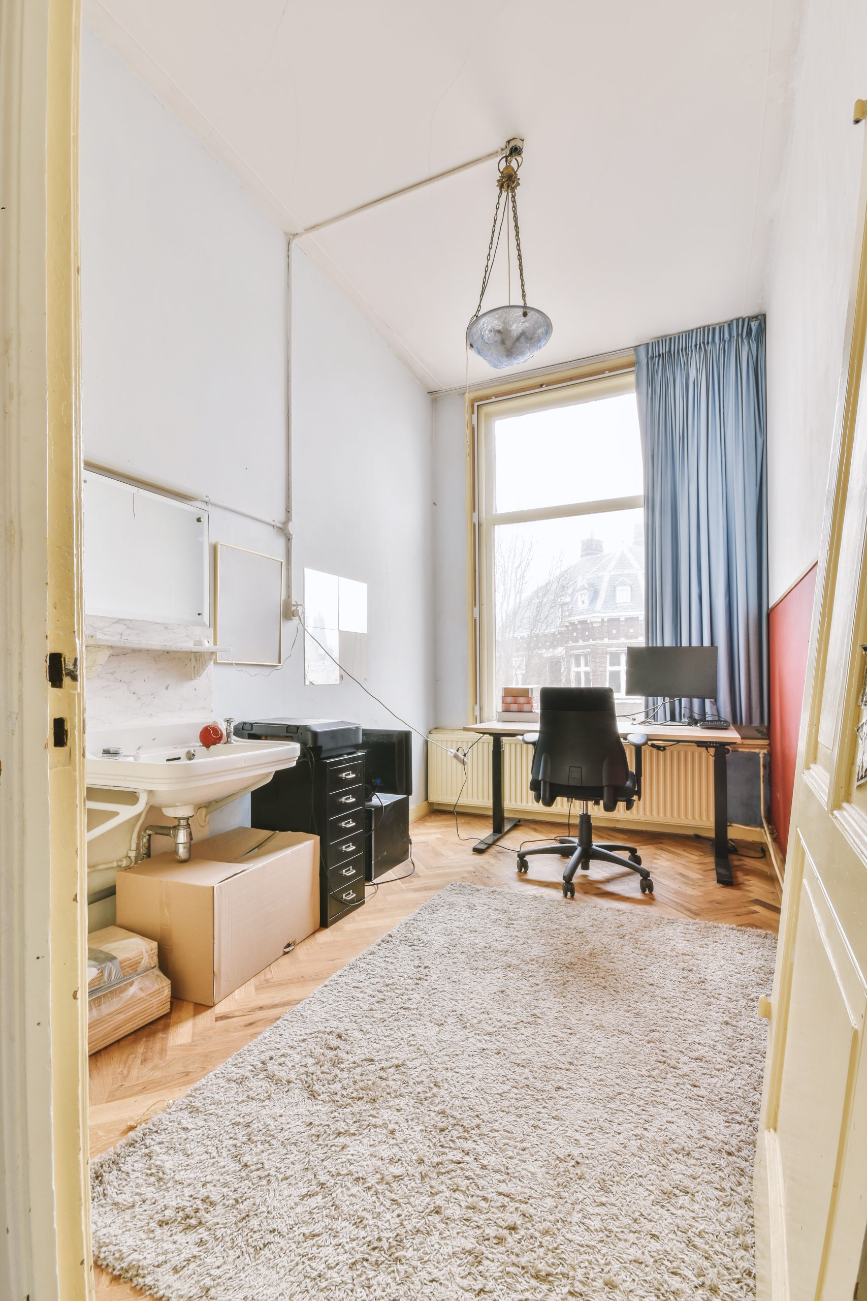 Home office room with sink, chandilier, desktop and etc.